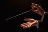 Concert conductor hands with baton