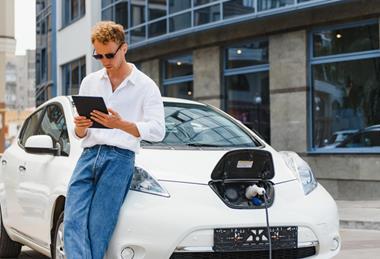 Man with Nissan EV on tablet (1)