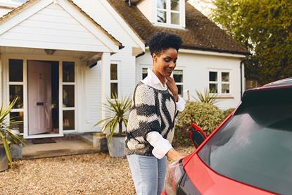 Woman Charging Red Car at Home 1000x1000
