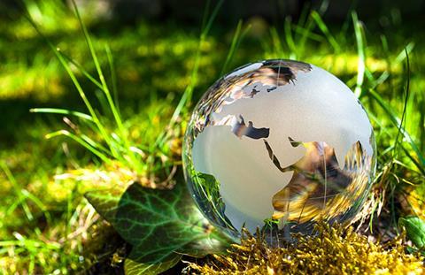 Globe and grass shutterstock 1228582321