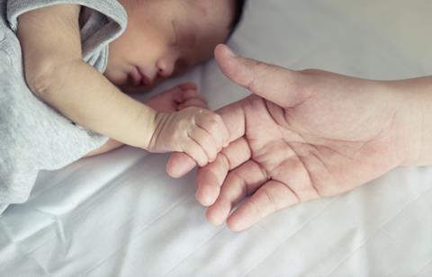 Baby-and-parent-holding-hands