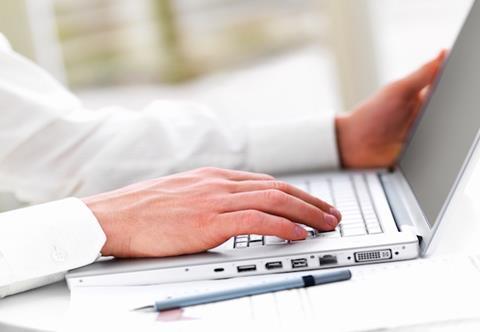 Close-up of a business man's hands working on laptop