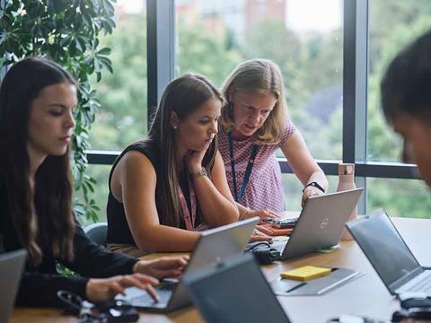 Image shows Jisc apprentices sitting at a table on an induction day