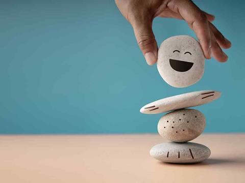 Pebbles with faces drawn on symbolising mindfulness and mental health