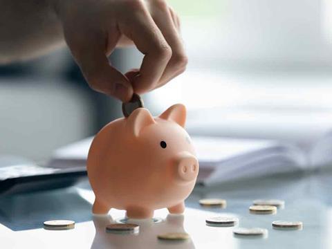 coins being put into a piggy bank