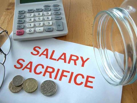 a calculator, glasses, coins and a sign that says salary sacrifice