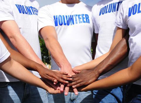 a group of people wearing volunteering t-shirts