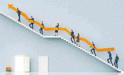 people going up stairs holding a long arrow